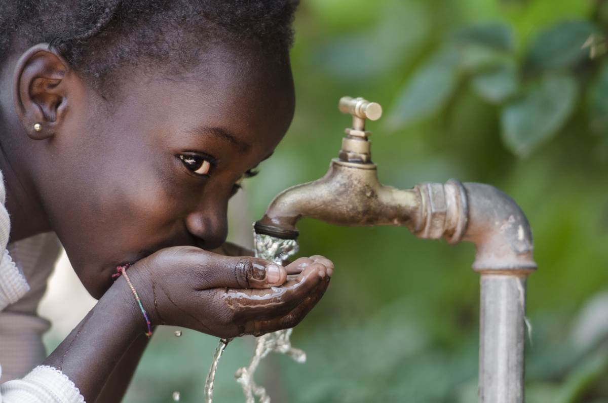 girl drinking clean water in Africa