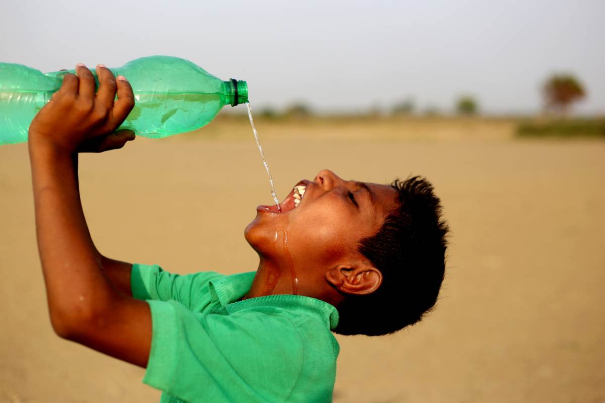Indian boy drinking clean water